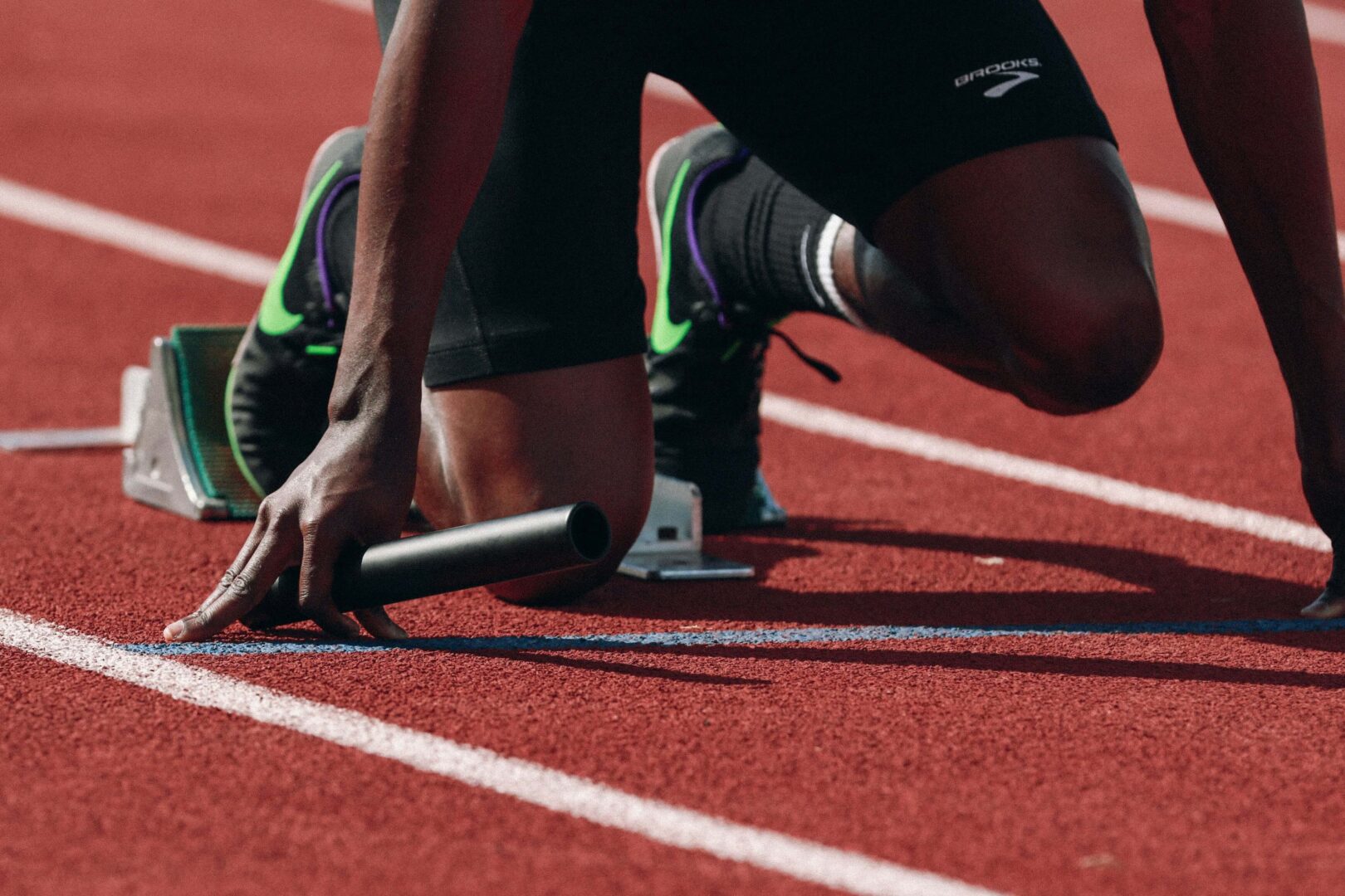Photo of a runner starting a race on a track.