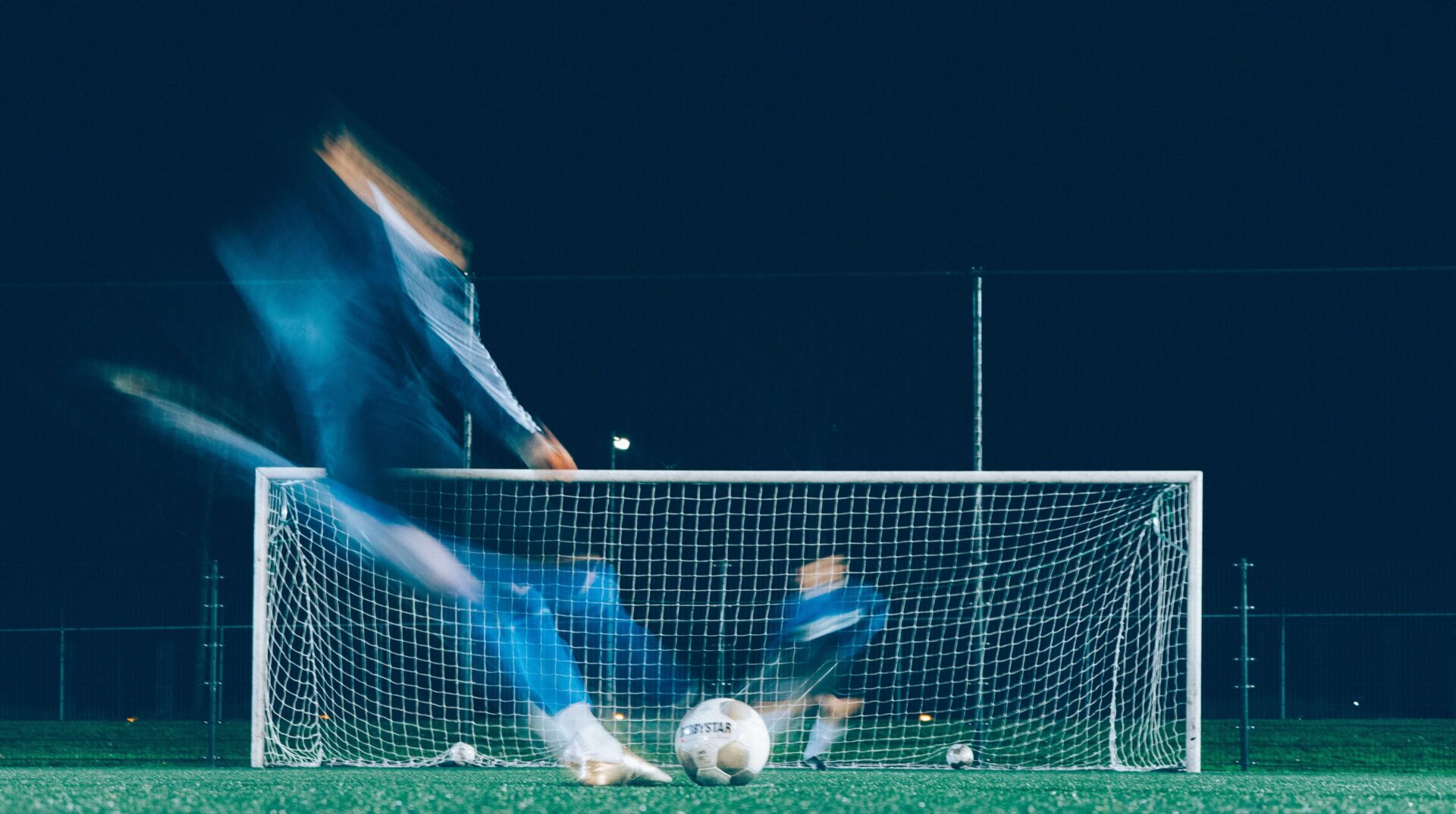 Photograph of football player scoring a goal