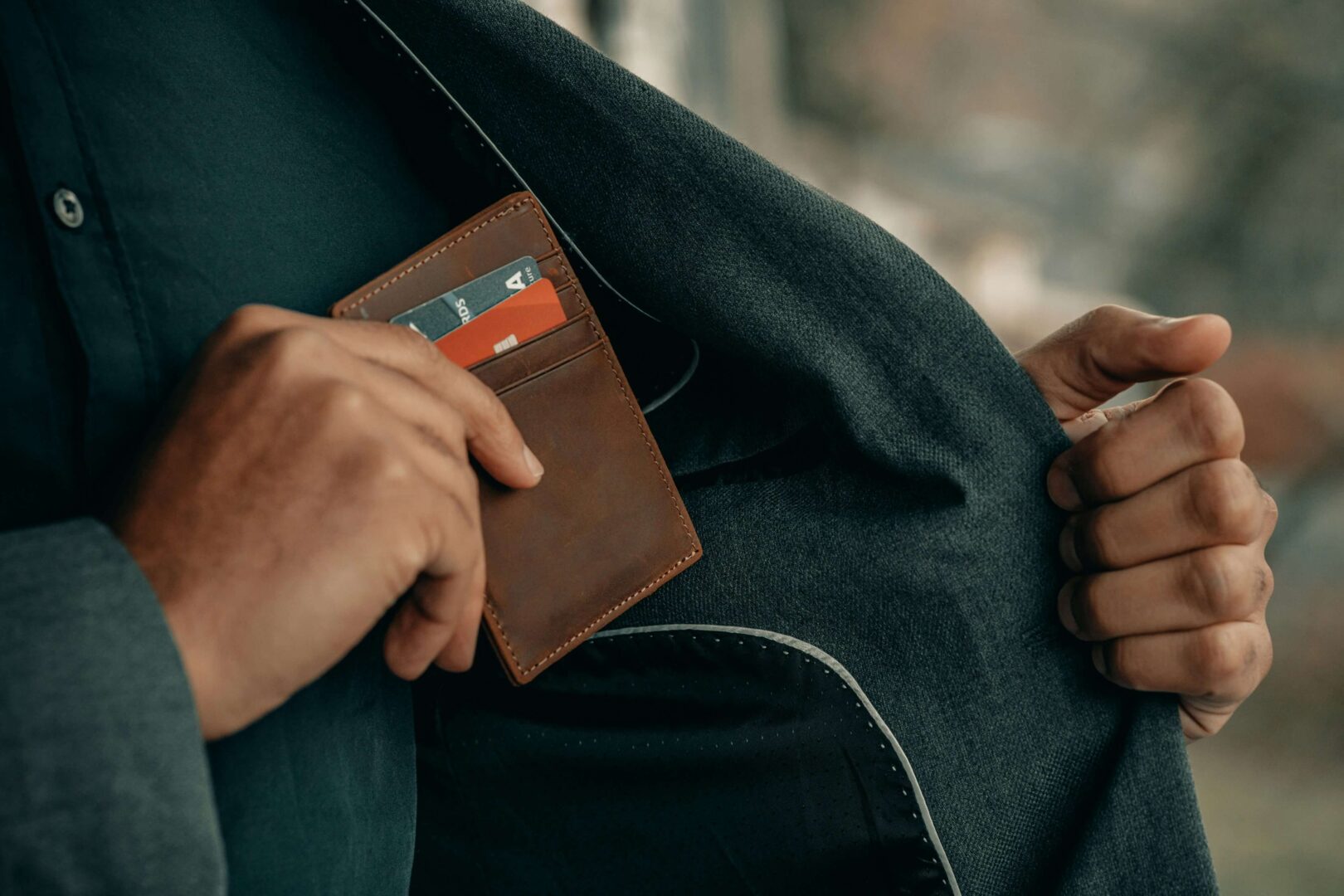 man-putting-wallet-into-jacket-pocket