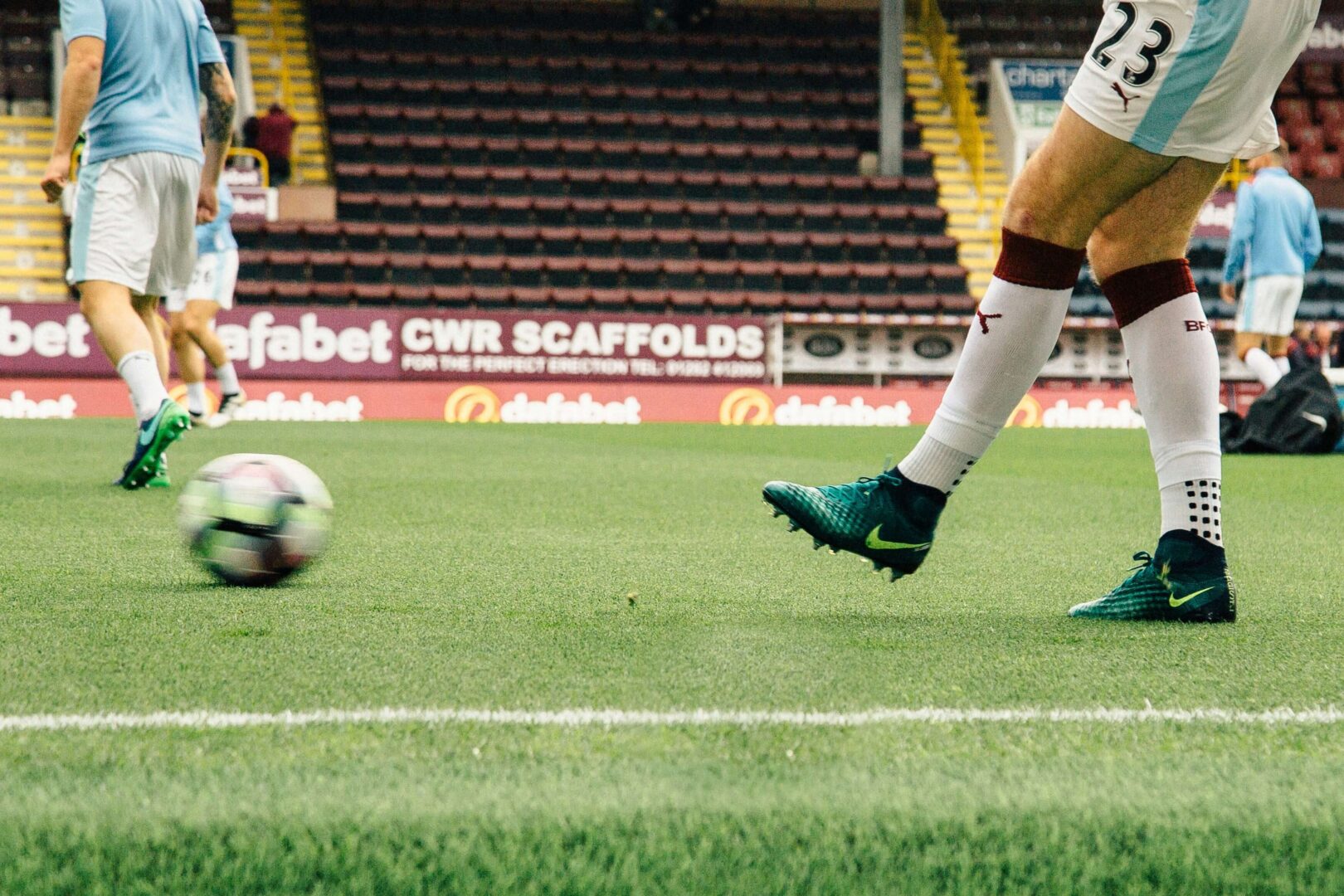 photograph-of-football-players-kicking-ball