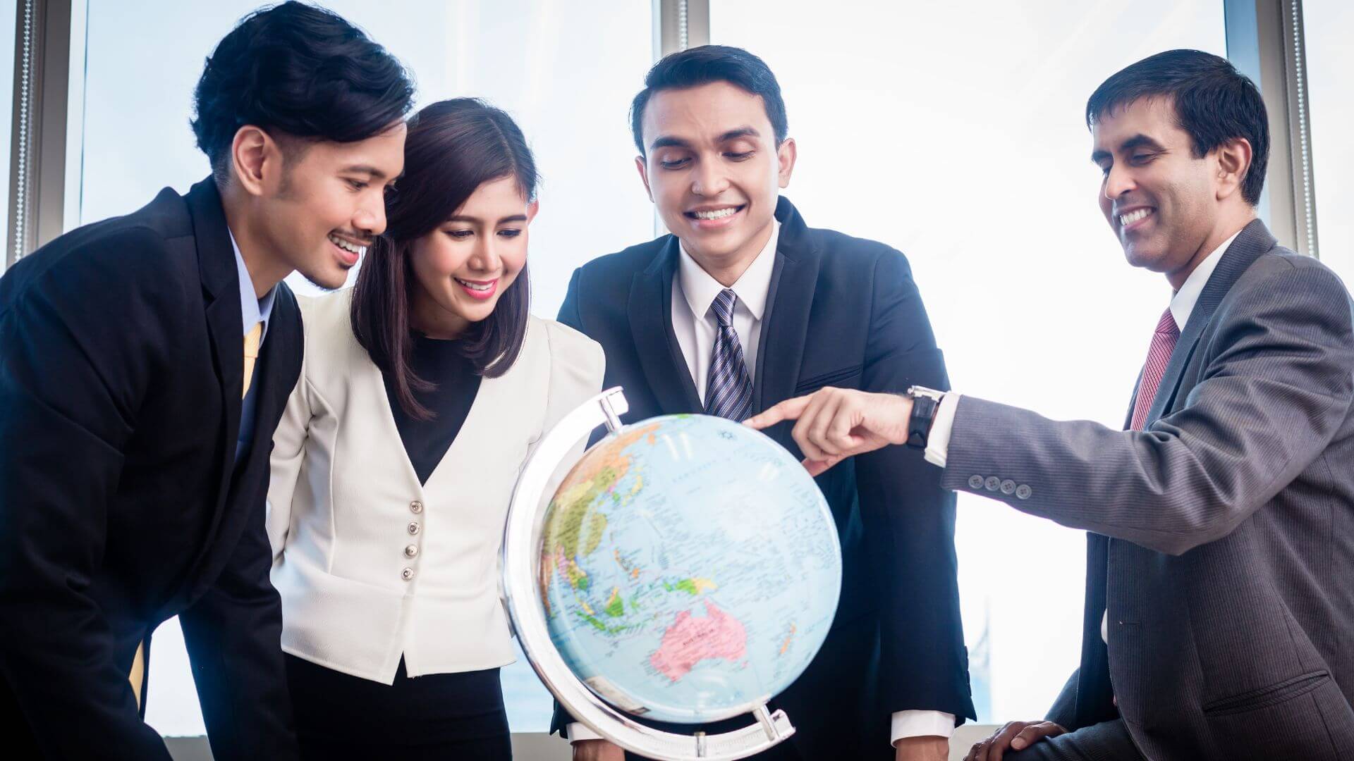 Employees Looking At A World Map