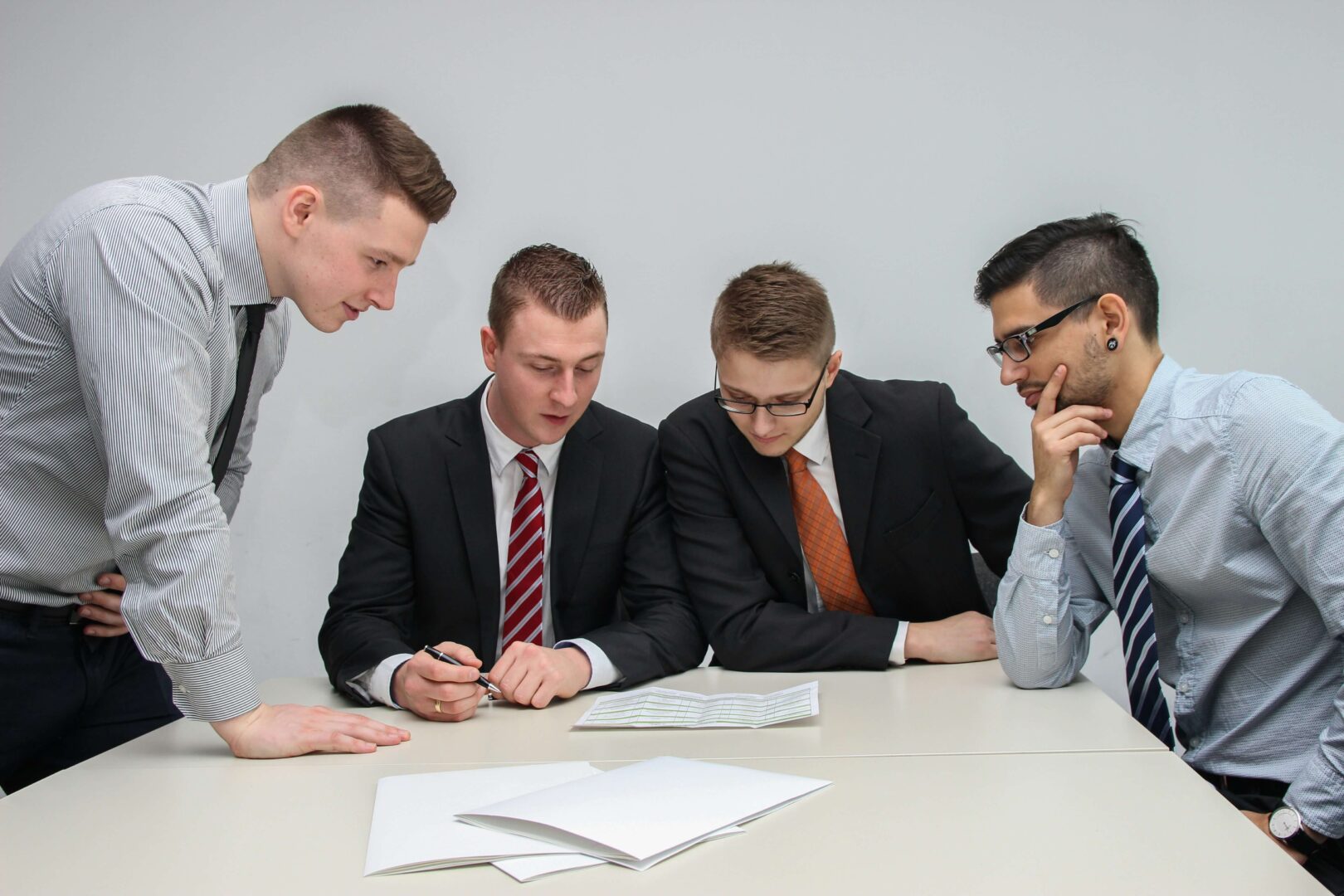men-sitting-at-boardroom-table