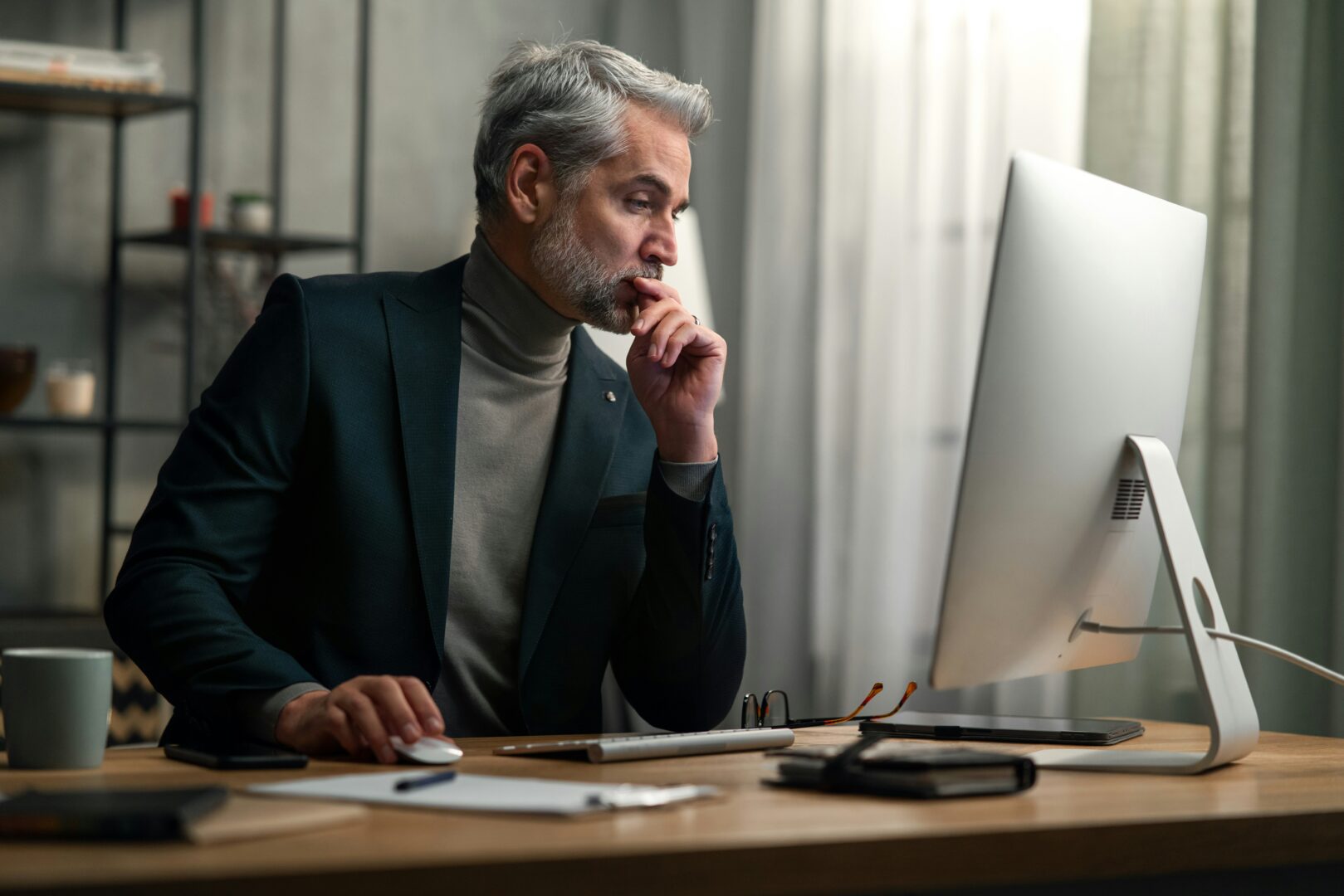 Man sitting at his desk working ons his computer