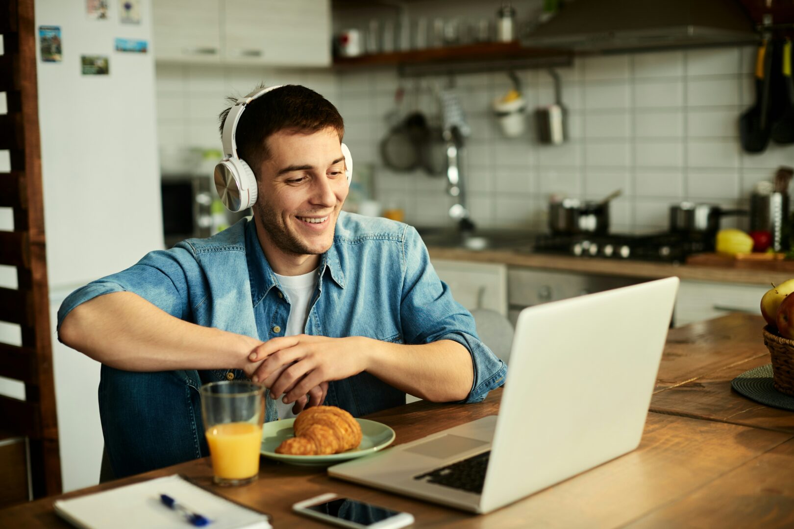 A man sitting at his desk at home while on a video call