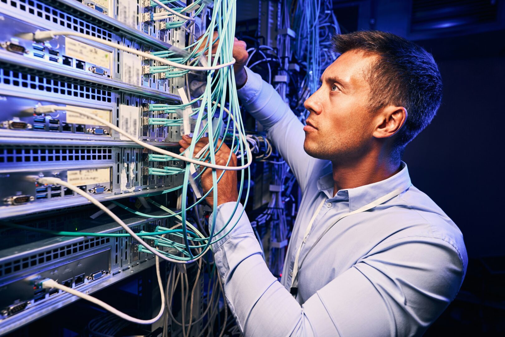 Man working on green cables