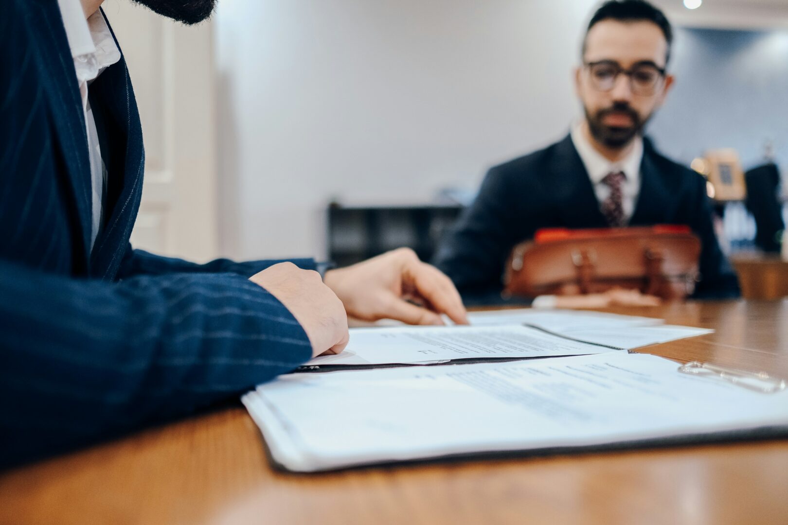 man-sitting-at-a-desk-with-papers