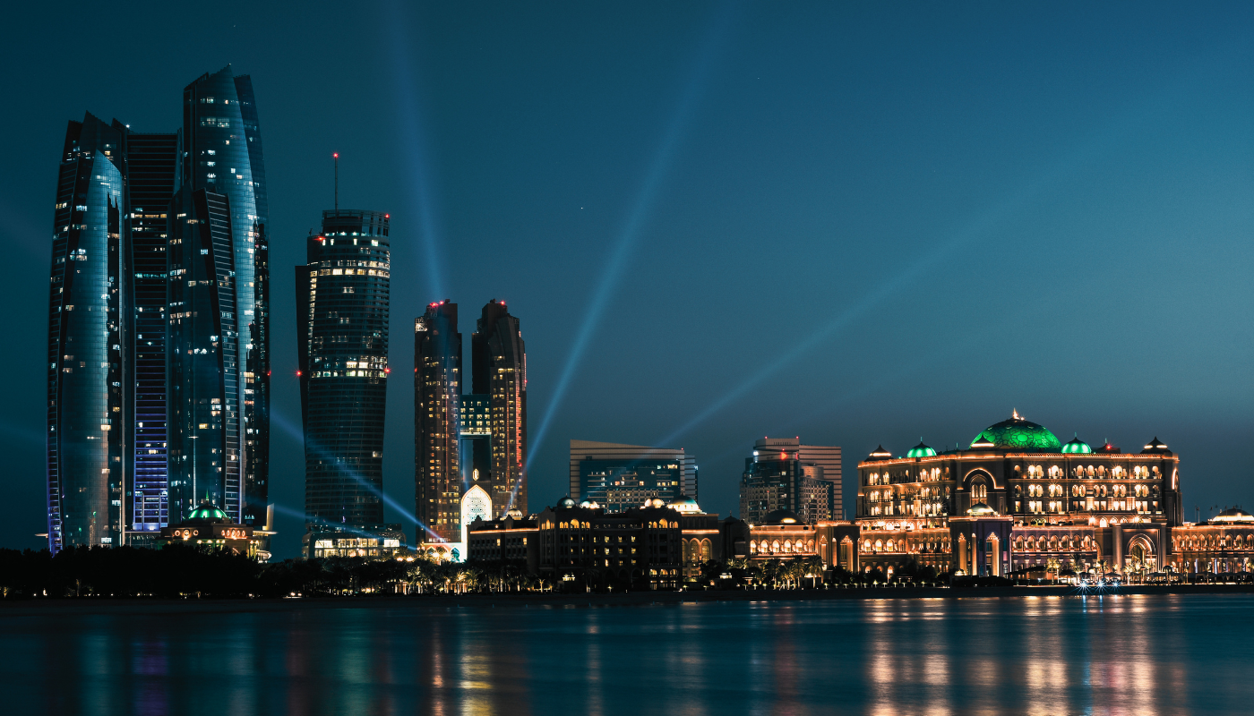 The Abu Dhabi skyline at dusk representing the Gulf region's investment in AI education and talent development, with institutions like MBZUAI training graduates specifically for the regional AI economy.